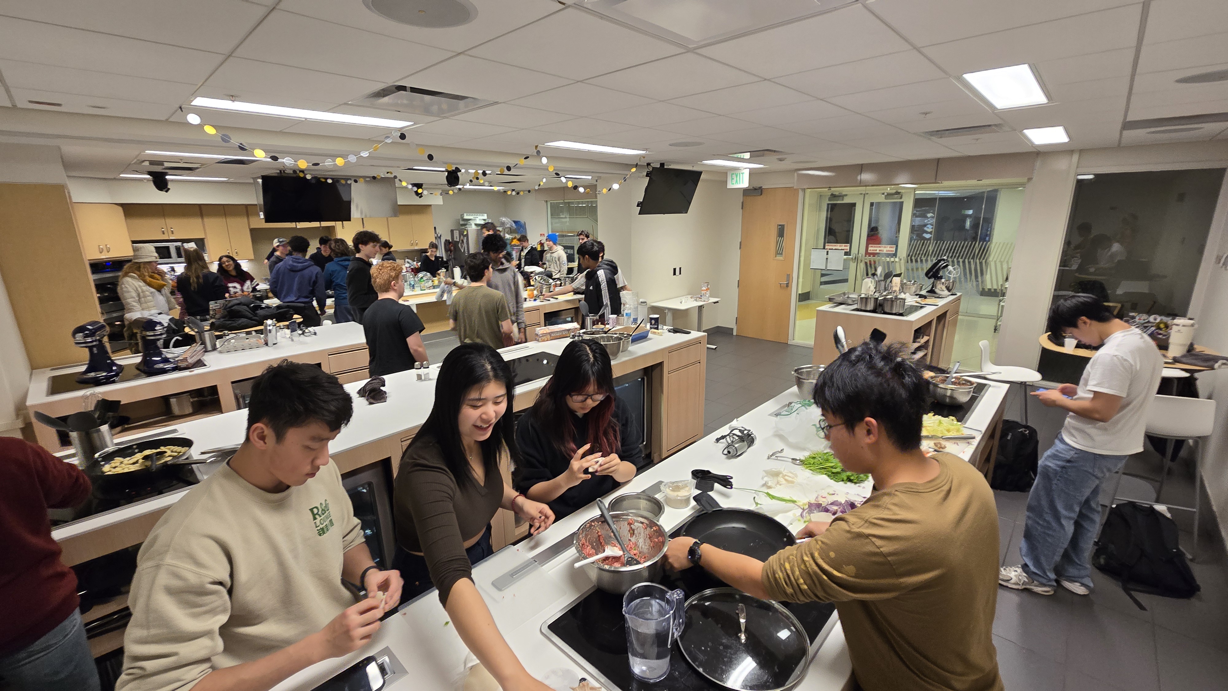 Students from the learning community making food in a practice kitchen for an event